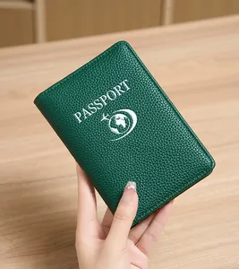 Detail of dark green RFID passport holder with pebble leather texture and logo