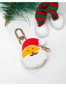 Close-up of Santa Claus cartoon coin purse with gold lobster clasp on festive background