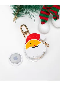 Detail of cartoon Santa leather case for AirTag with golden metal hook and festive decor