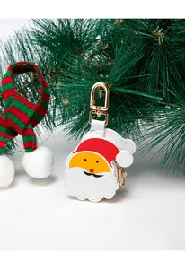 Detailed view of Santa Claus leather pouch with gold clip and festive holiday decor