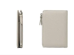 Detailed macro view of light gray litchi texture leather RFID passport holder with zipper