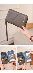 Brown leather RFID travel wallet with passport slots, card holders, and gold plane logo