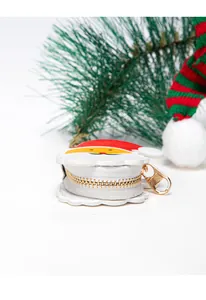 Detail view of Santa Claus leather coin purse with golden zipper and holiday decor