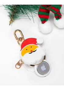 Close-up of Santa Claus AirTag case in white PU leather with gold lobster clasp