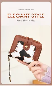 Detail of RFID blocking wallet with cow print contrast and anti-theft metal chain
