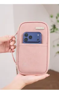 Λεπτομέρεια ροζ θήκης διαβατηρίου RFID με smartphone στην μπροστινή εξωτερική τσέπη