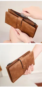 Detail view of brown vintage leather wallet showing zipper pocket and card slot sections