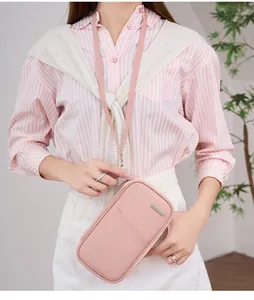 Pink RFID passport holder with neck strap shown on a model in a stylish lifestyle setting