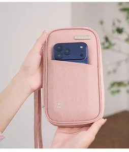 Pink RFID blocking travel passport pouch showing smartphone storage and fabric texture