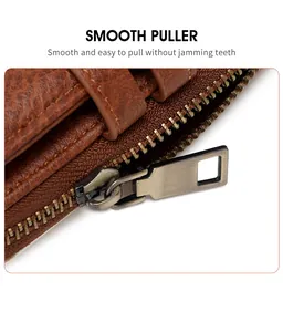 Detail shot of smooth bronze metal zipper and litchi grain leather on a small wallet