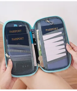 Handheld view of sky blue RFID travel wallet showing multi-slot storage and pen holder