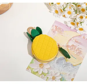 Détail du mignon porte-monnaie ananas en cuir litchi jaune avec fermeture éclair dorée