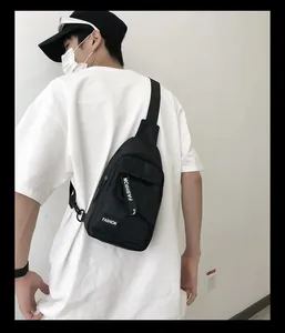 Rear view of a black nylon crossbody bag with fashion print on a male model