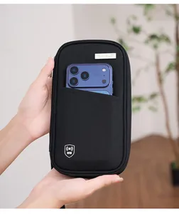 Close-up of black RFID blocking travel pouch showing a smartphone in the front pocket