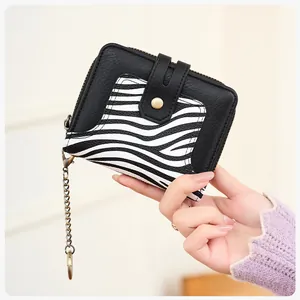 Detail of zebra print and black leather wallet with RFID protection and key chain hook