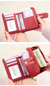 Detail view of red RFID blocking leather wallet featuring card slots and zipper pouch