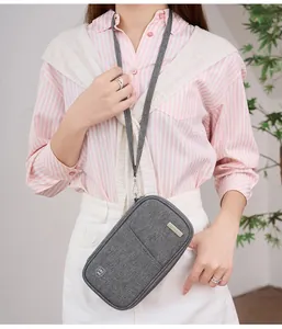 Gray RFID blocking passport pouch with adjustable neck strap shown on a casual model