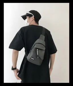 Rear view of a man wearing a grey nylon chest bag with adjustable black shoulder strap
