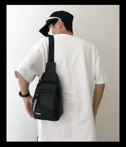 Close-up detail of durable black nylon chest bag featuring FASHION branded straps