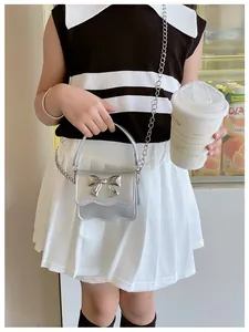 Silver mini PU handbag for girls featuring bow decoration and metal chain strap details