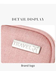 Detailed macro shot of pink waterproof fabric and metal logo with aircraft icon