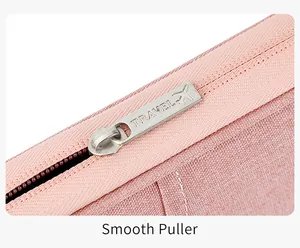 Detail showing high-quality silver travel metal zipper puller on pink waterproof fabric