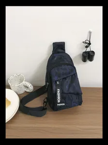 Detail of dark blue camo chest bag featuring nylon fabric and Fashion logo zipper pull