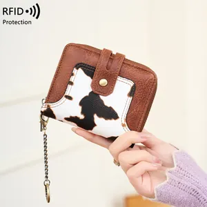 Short RFID blocking women's wallet with brown leather and cow print patchwork design