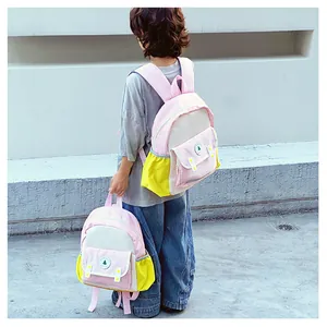 Detailed view of kids backpack with pink and yellow stitching and side mesh pocket