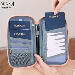 Pink waterproof RFID blocking passport holder with multi-compartment travel organizer slots