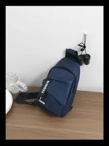 Detail of navy nylon cross-body chest bag featuring fashion letter print and zipper pocket