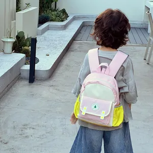 Toddler backpack with pink and yellow color block design and Good Luck embroidery