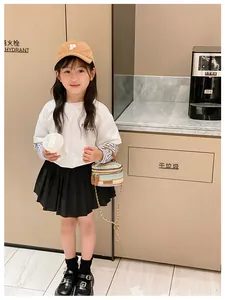 Kid's colorful woven chain shoulder bag shown with trendy Korean style outfit and accessories