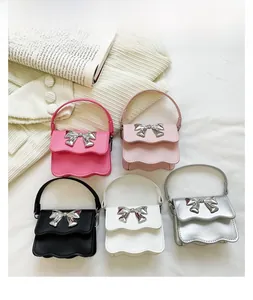Flat lay of mini PU leather handbags in five colors featuring metallic bow and wavy flap