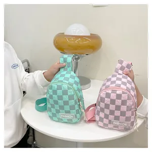 Close-up of kids checkered nylon chest bags in pink and green with fashion label