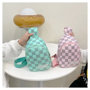 Detailed view of mini checkered nylon chest bags in mint green and soft pink colors