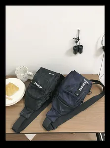 Detailed view of camouflage nylon crossbody bags on a table with travel accessories