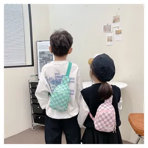 Rear view of children wearing checkered nylon chest bags in green and pink patterns