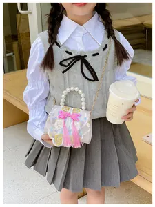 Detailed embroidery flowers and pink tassel on kid's traditional style handbag