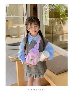 Pink striped crossbody bag with tulip flower details worn by a child in a cafe