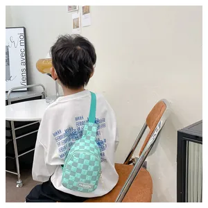 Detail of mint green checkerboard kids chest bag with adjustable strap and FASHION tag