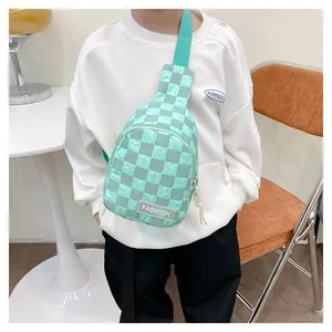 Detailed view of the mint green checkerboard kids chest bag with a stylish fashion label