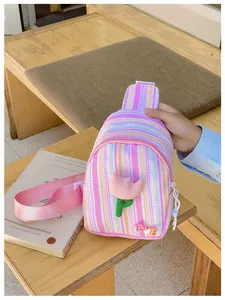 Detail of pink striped kids crossbody bag featuring a plush tulip and LOVE letters