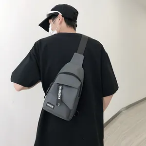 Grey nylon crossbody chest bag with fashion letter tag shown on a male model