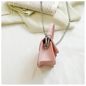 Side view of small pink PU handbag with silver chain strap and metal clasp detail