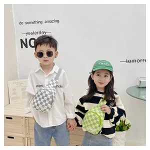 Detail showing kids' checkered nylon chest bags in grey and green with fashion labels