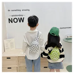 Detail of checkered crossbody bags for kids in grey and green colors on models