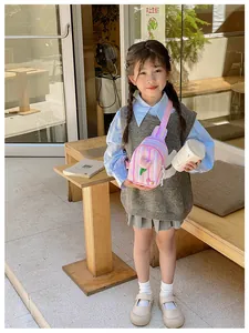 Girl's crossbody bag featuring pink stripes and a 3D tulip detail in a street setting