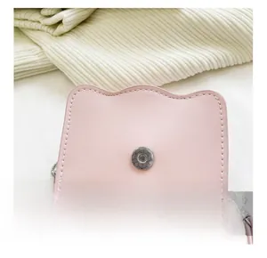 Detail of pink PU leather bag featuring magnetic silver buckle and wavy edge stitching