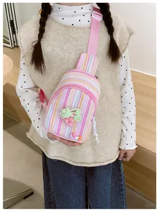 Detail of kids striped crossbody bag with cute 3D pink grape and 'LOVE' charm